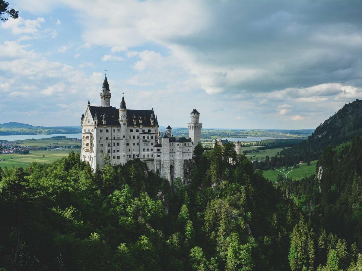 A castle rising out of forested hills